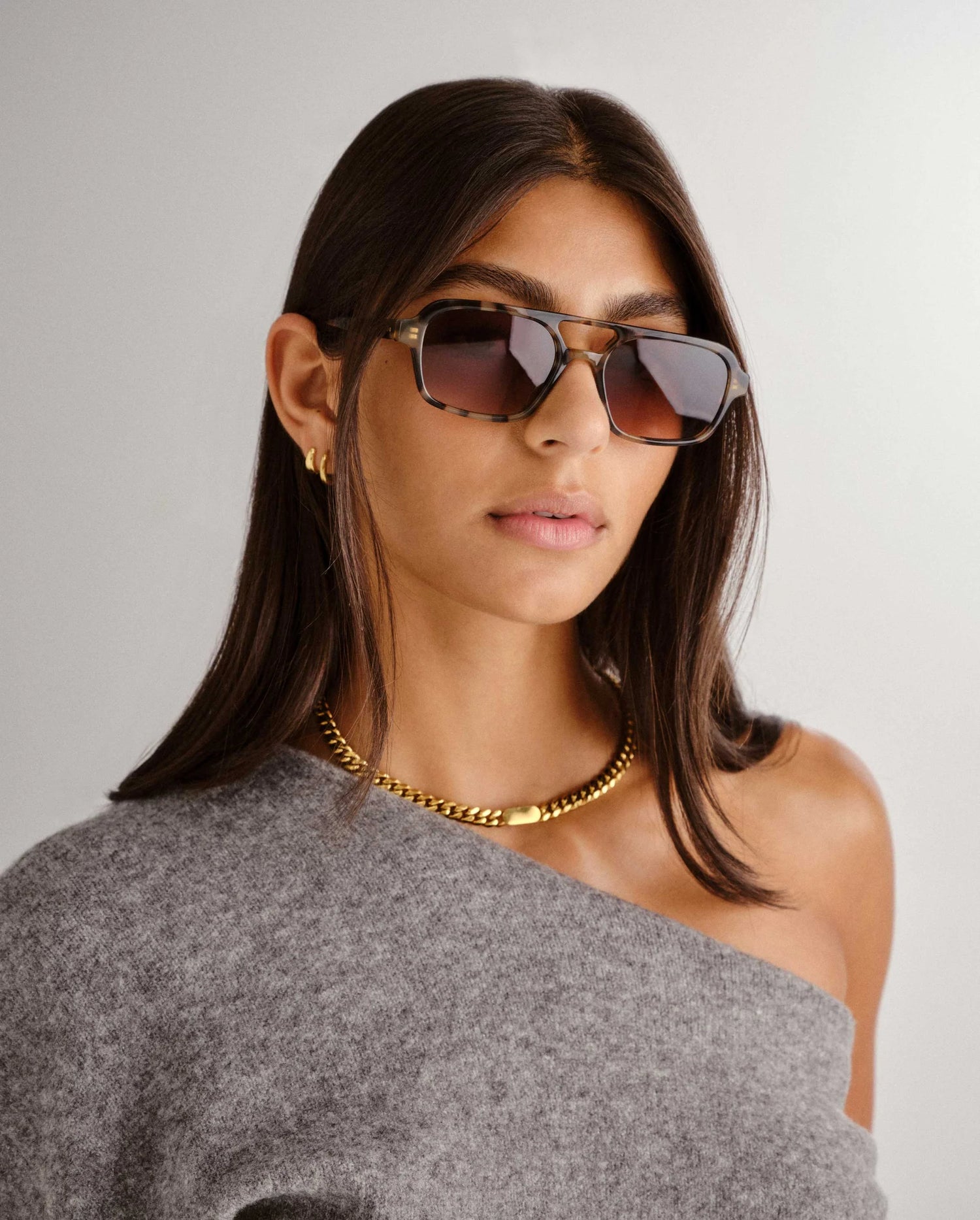 Woman wearing luv lou sunglasses shop at Studio Row